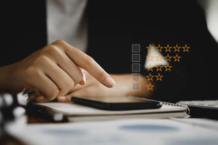 Close-up people using smartphones, customers reviewing products and services on smartphones, rating...