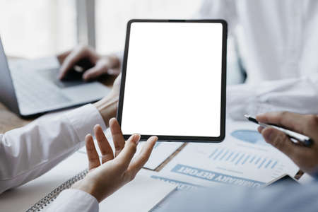 Person holding tablet at blank screen copy space, meeting of business people, founders and partners...