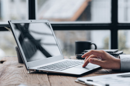 Close-up business man working in a private room, He is typing on a laptop keyboard, He uses a...