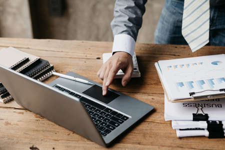 Close-up business man working in a private room, He is typing on a laptop keyboard, He uses a...