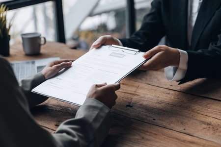 Person submitting resume to interview for a job with a company, Person attending a job interview...