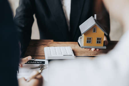Real estate agents are carrying a housing model of the project to be forwarded to customers as home...