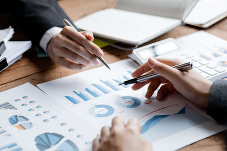 Asian business man are meeting to summarize the company's operating, financial, profit and loss...