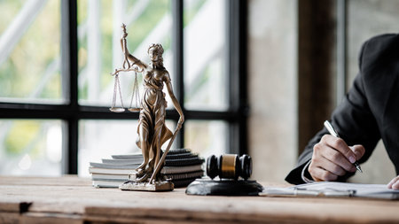 A statue of the goddess of justice is placed on the table in the judge's office, preserving law and justice. The concept of judging whether a legal matter is correct and fair.の写真素材