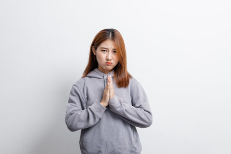 Portrait of beautiful Asian woman gesturing worried expression on isolated background, portrait concept used for advertisement and signage, isolated over white background, copy space.の写真素材