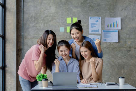 A group of young Asian business women showing joy. Jointly open a startup company and a business plan management plan to grow the business and be profitable by the concept of the new generation.の写真素材