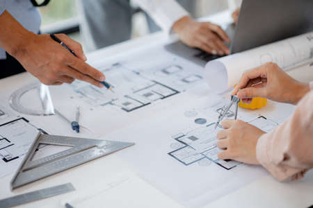 A group of architects designing buildings and houses is having a meeting with the project owners...