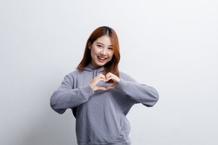 Beautiful Asian woman gesturing for advertisement editing on isolated background, portrait concept used for advertisement and signage, isolated over white background, copy space.の写真素材