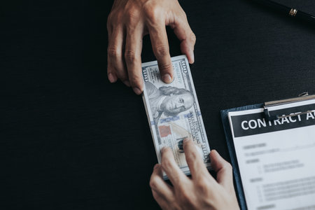 Individuals are giving bribes to officials in order to commit corruption in lawsuits, illegal actions by law enforcement by paying bribes to officials are illegal and unlawful. Fraud concept.の写真素材