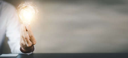 Standing woman holding light bulb, Creative new idea. Innovation, brainstorming, strategizing to...