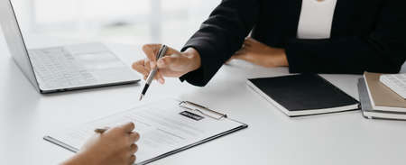 The HR department is reviewing the resumes of job applicants, resumes are important documents for job application. It should contain resume, training history, education, talent, work skills, etc.の写真素材