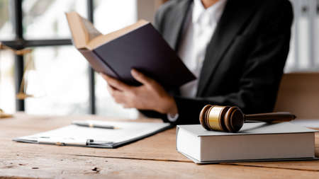 The judge's hammer is placed on the table, the lawyer concept assumes that the defendant defends the...