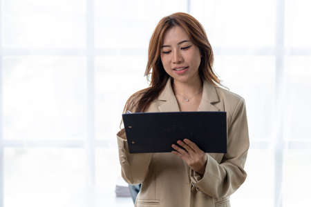 Beautiful Asian woman is a businesswoman who leads a new generation of startups, a woman who runs and manages a business plan to build confidence and stability in business, woman-led business concept.の写真素材
