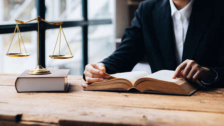Lawyers read legal books defend their clients' cases, the lawyer concept assumes that the defendant defends the client in order to win the case or gain the greatest benefit in accordance with the law.の写真素材