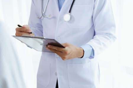 Doctors are giving advice on treatment to patients in hospital examination rooms, treating diseases from specialists and providing targeted treatment. Concepts of medical treatment and specialists.の写真素材