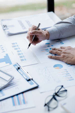 A female financier is reviewing company financial documents, monthly financial statement summary...