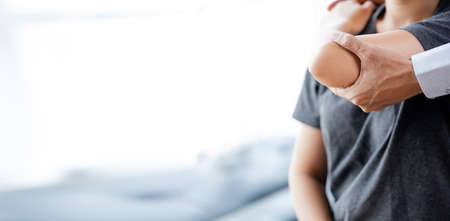 Professional physiotherapists are working to relax the muscles for patients who are treated for muscle disorders, most patients are office workers who sit for a long time causing pain. office syndromeの写真素材