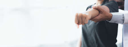 Professional physiotherapists are working to relax the muscles for patients who are treated for muscle disorders, most patients are office workers who sit for a long time causing pain. office syndromeの写真素材