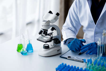 Laboratory assistants are investigating chemical reactions, medical scientists, chemical researchers, chemical experiments and disease testing from patient blood samples. Medicine and research conceptの写真素材