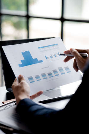 Business men are looking at the company's financial documents to analyze problems and find solutions...