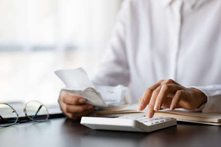 People are pressing calculators and carrying bills and bills to systematically allocate income and expenses, financial planning to keep finances in order. Personal finance management concept.の写真素材