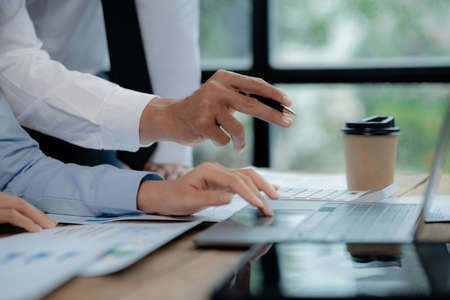 Atmosphere of a startup company meeting, business people are meeting together to summarize and plan investment finances, they are the founders of the company. Business administration concept.の写真素材