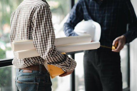 Two architects and engineers are in a meeting to discuss house designs according to building and construction standards before presenting them to clients. Interior design and decoration ideas.の写真素材