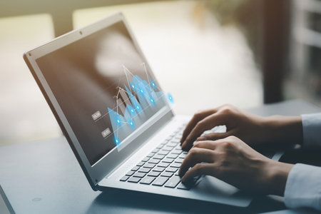A businessman examines data on financial documents, company financial reports, graphics showing financial and numerical growth data. The concept of financial management to grow and be profitable.の写真素材