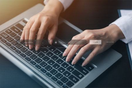 An individual is typing on a keyboard laptop showing a hologram interface to a member login, a...