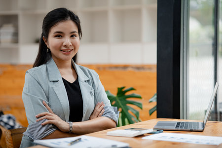 Portrait of a young beautiful Asian woman in a office room, concept image of Asian business woman,...