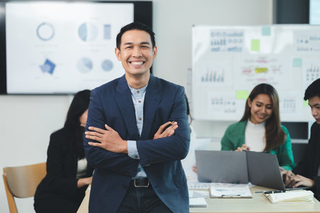 Close-up shot of a man meeting in a startup company meeting room, he is a marketing worker attending meetings with executives and employees to plan a sales boost. Sales management concept.の写真素材