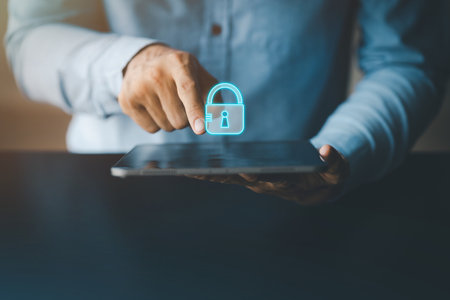 Person pointing at tablet screen with padlock icon, tablet data access lock for data privacy and security, protection and protection against personal data infringement.の写真素材