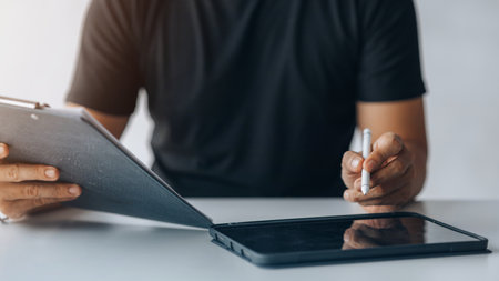 Business men are looking at the company's financial documents on tablets to analyze problems and...