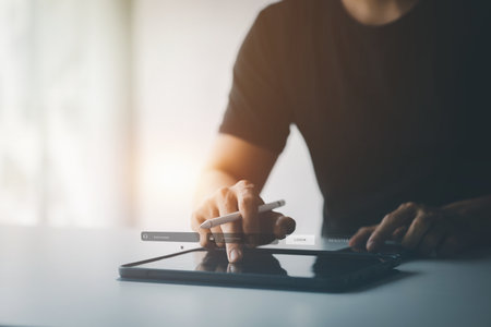 An individual is typing on a keyboard laptop showing a hologram interface to a member login, a businessman is going to access the company's membership system, check the information of the parties.の写真素材