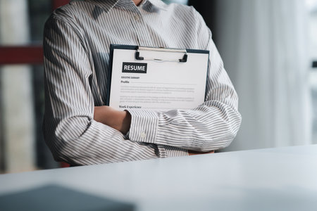 The HR department is reviewing the resumes of job applicants, resumes are important documents for job application. It should contain resume, training history, education, talent, work skills, etc.の写真素材