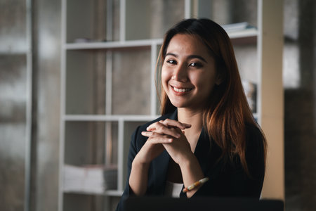 Asian women working in the office, young Asian business women as business executives, founding and running start-up executives, young female business leaders. Startup business concept.の写真素材