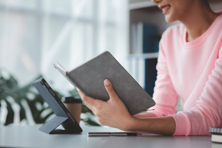 Asian women working in the office, young Asian business women as business executives, founding and...