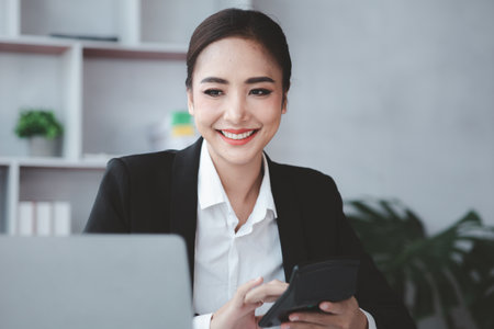 Beautiful Asian woman is a businesswoman who leads a new generation of startups, a woman who runs and manages a business plan to build confidence and stability in business, woman-led business concept.の写真素材