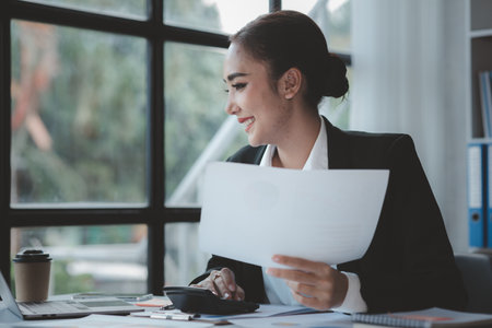 Beautiful Asian woman is a businesswoman who leads a new generation of startups, a woman who runs and manages a business plan to build confidence and stability in business, woman-led business concept.の写真素材