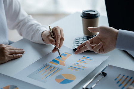 Two businessmen pointed to the material for the meeting, working together to plan to develop and...