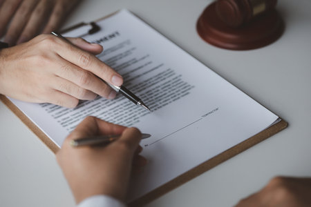 A female financier is reviewing company financial documents, monthly financial statement summary from the finance department. The concept of managing the company's finances for accuracy and growth.の写真素材