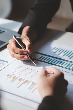 The sales department is having a monthly summary meeting to bring it to the department manager, they are verifying the correctness of the documents that are prepared before bringing in to the managerの写真素材