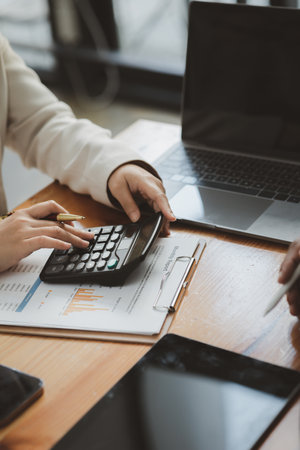 The sales department is having a monthly summary meeting to bring it to the department manager, they are verifying the correctness of the documents that are prepared before bringing in to the managerの写真素材