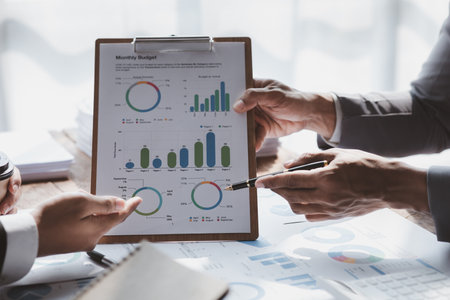 The sales department is having a monthly summary meeting to bring it to the department manager, they are verifying the correctness of the documents that are prepared before bringing in to the managerの写真素材