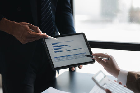 The sales department is having a monthly summary meeting to bring it to the department manager, they are verifying the correctness of the documents that are prepared before bringing in to the managerの写真素材