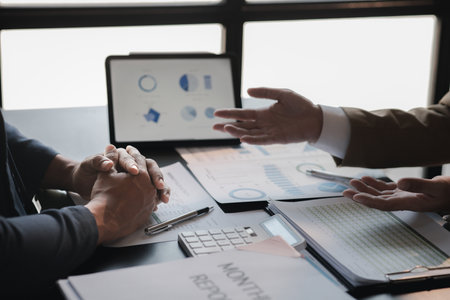 The sales department is having a monthly summary meeting to bring it to the department manager, they are verifying the correctness of the documents that are prepared before bringing in to the managerの写真素材