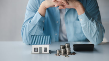 Person with stack of coins, saving money concept for future use and financial stability, savings for housing, payroll management, personal finance, investment savings.の写真素材