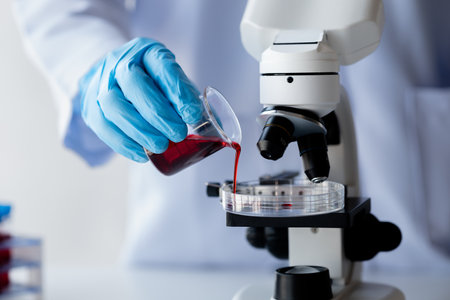 Lab assistant, a medical scientist, a chemistry researcher holds a glass tube through the blood...