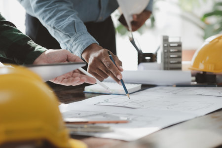 The home design architects are reviewing the house plan draft, the project commissioned by the client, and the custom design before delivery. Interior design and decoration ideas.の写真素材