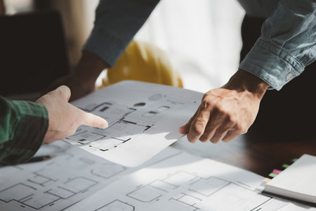The home design architects are reviewing the house plan draft, the project commissioned by the client, and the custom design before delivery. Interior design and decoration ideas.の写真素材